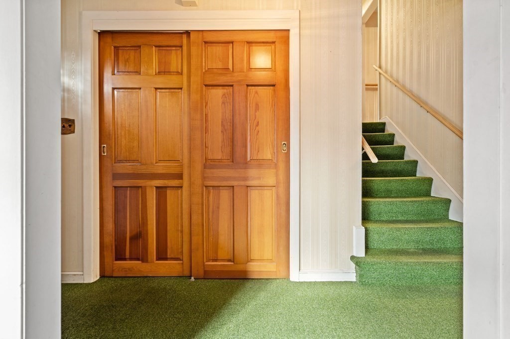 11 Christopher Drive Milton, MA 02186 - Photo 13 of 34 an entryway with wooden floor and cabinet
