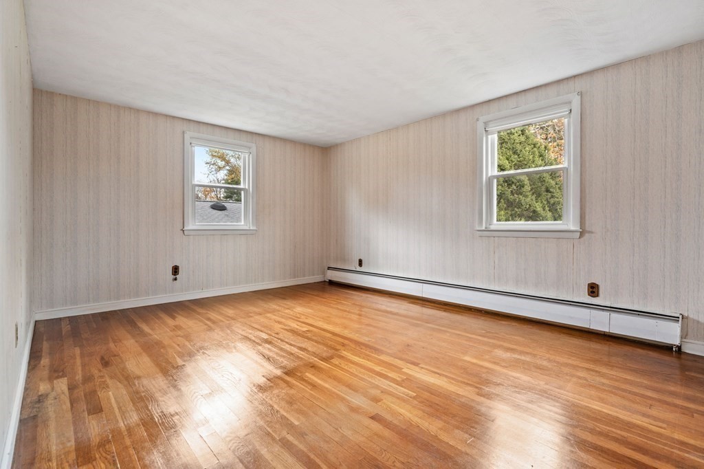 11 Christopher Drive Milton, MA 02186 - Photo 15 of 34 a view of an empty room with wooden floor and a window