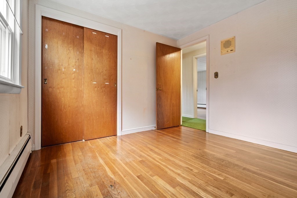 11 Christopher Drive Milton, MA 02186 - Photo 17 of 34 a view of an empty room with wooden floor and a window