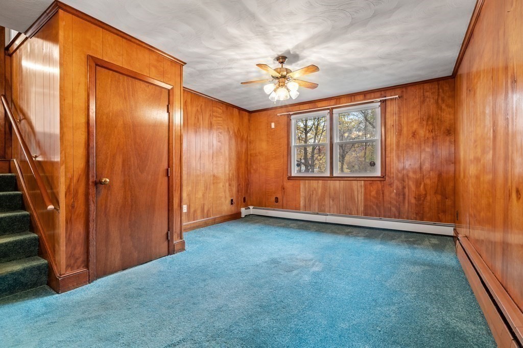 11 Christopher Drive Milton, MA 02186 - Photo 20 of 34 an empty room with windows and chandelier fan