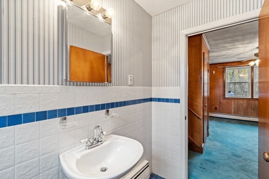 11 Christopher Drive Milton, MA 02186 - Photo 23 of 34 a bathroom with a sink a mirror and a shower