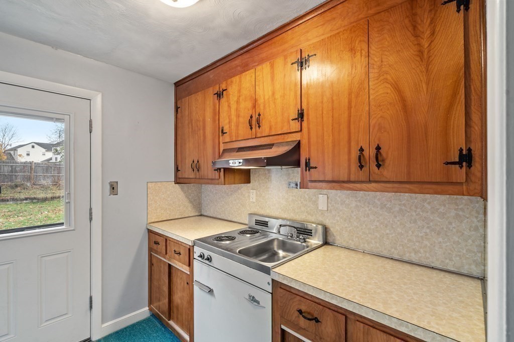11 Christopher Drive Milton, MA 02186 - Photo 24 of 34 a kitchen with a stove a sink and a microwave