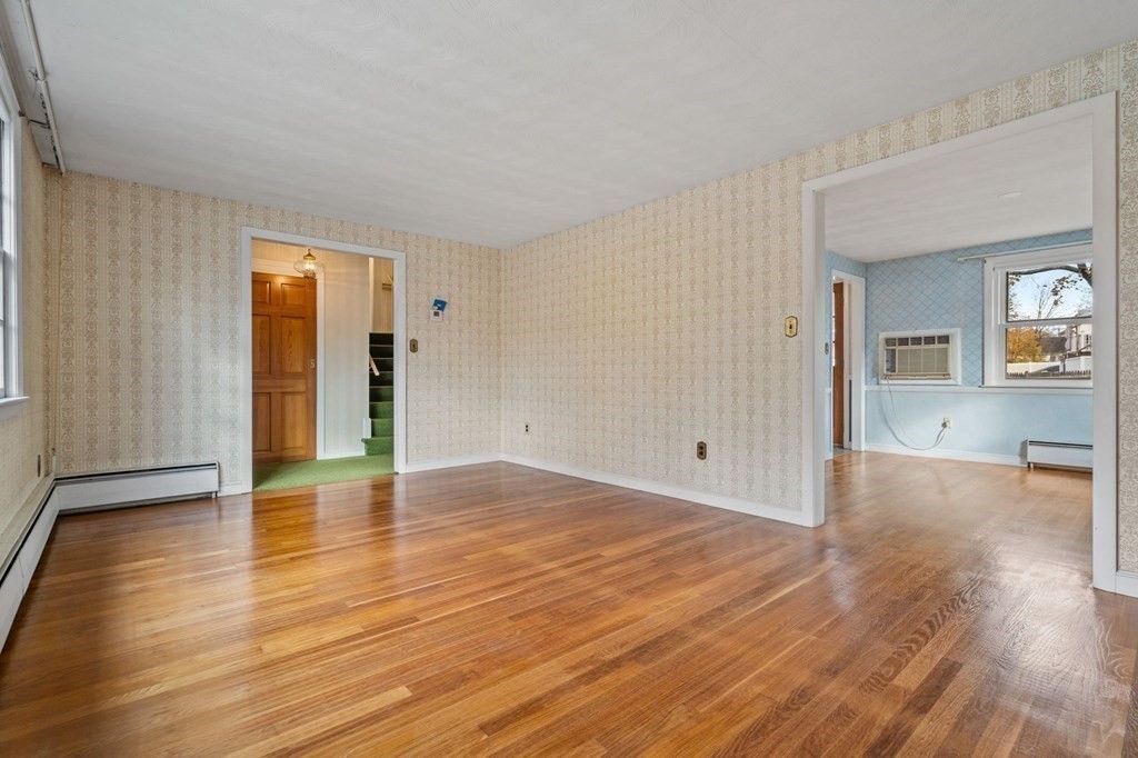 11 Christopher Drive Milton, MA 02186 - Photo 6 of 34 a view of an empty room with wooden floor and a window