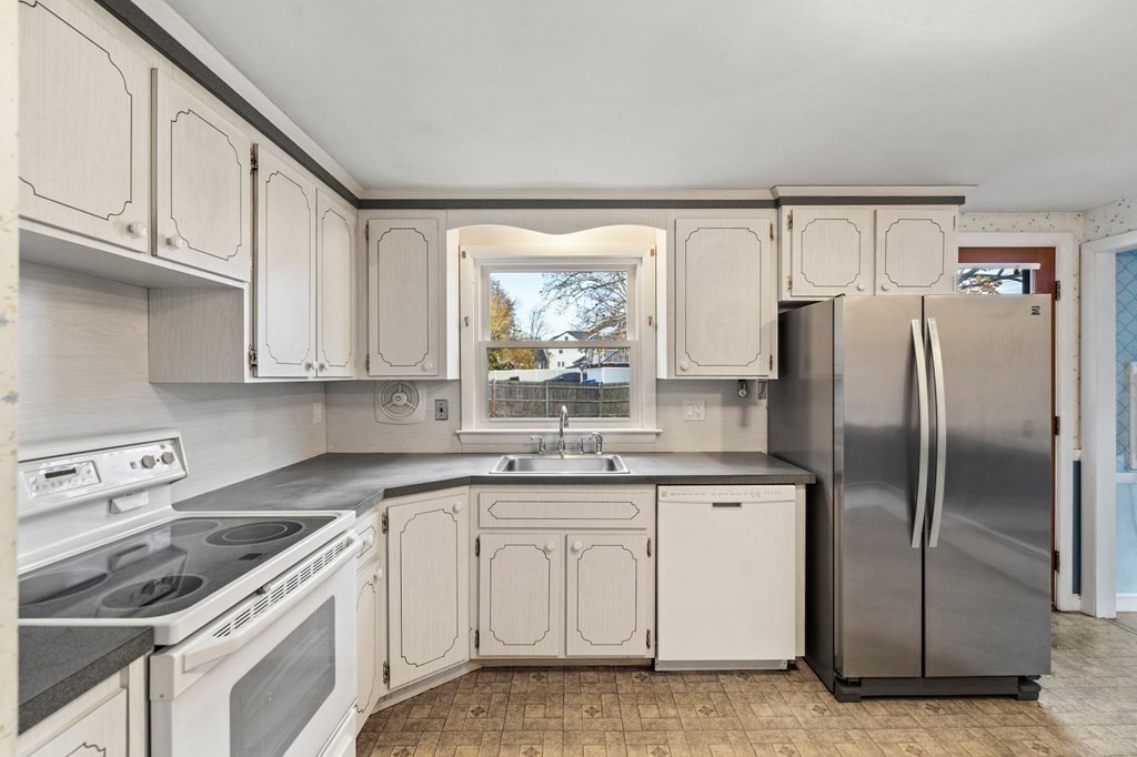 11 Christopher Drive Milton, MA 02186 - Photo 10 of 34 a kitchen with a sink a refrigerator and cabinets