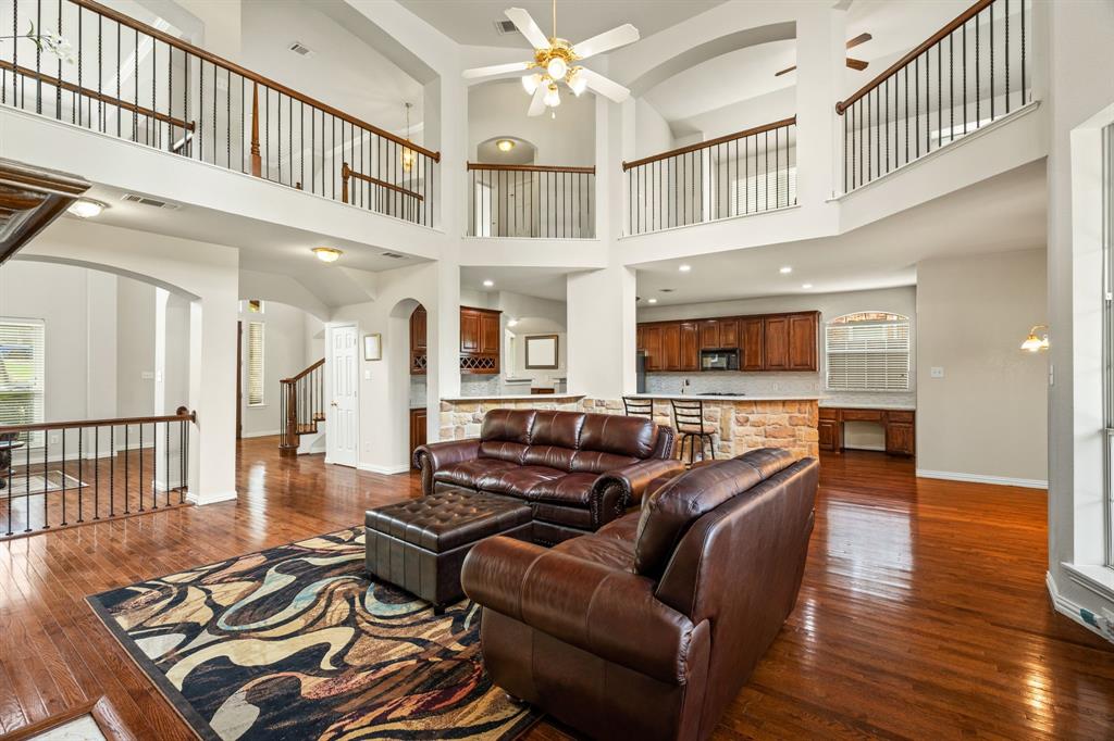 2012 Burnside Drive Allen, TX 75013 - Photo 13 of 40 a living room with furniture or wooden floor and a chandelier