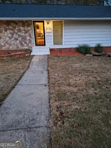 a view of backyard with window and door