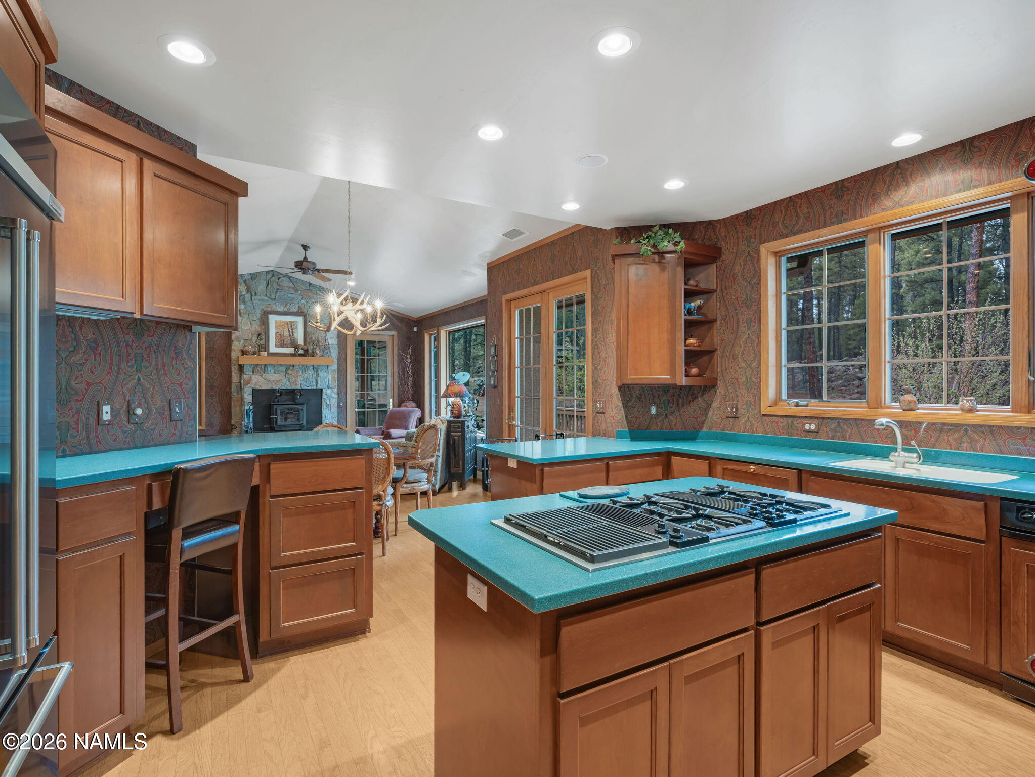 5415 North Fort Valley Road Flagstaff, AZ 86001 - Photo 18 of 64 a kitchen that has a kitchen island wooden cabinets and stainless steel appliances