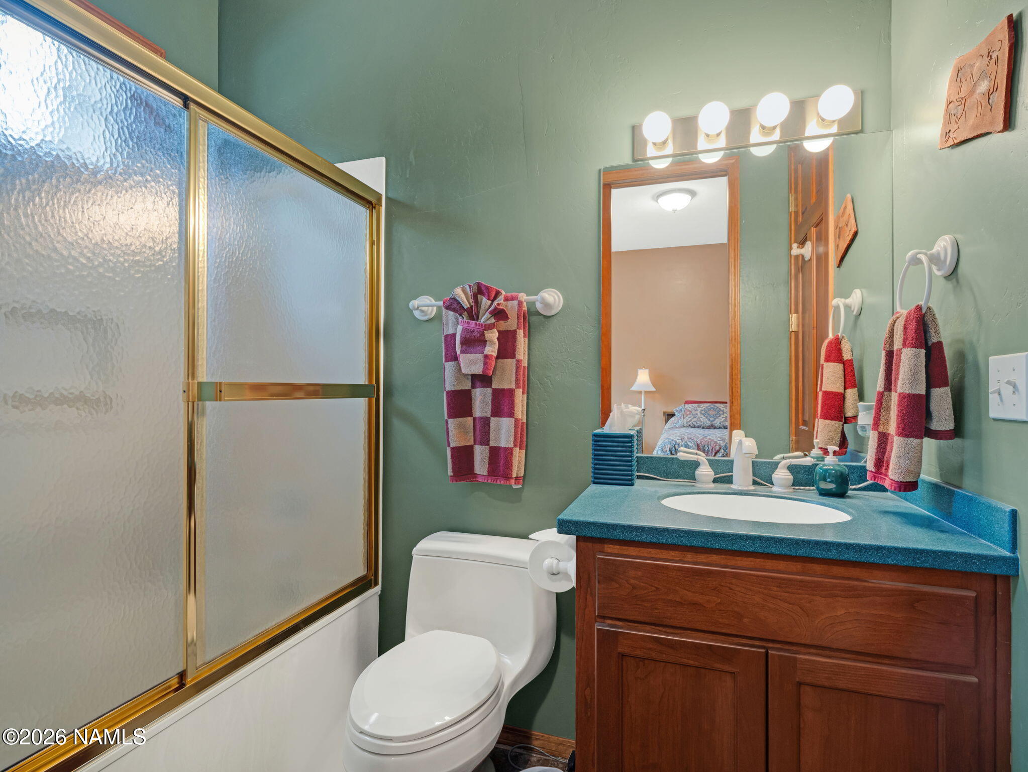 5415 North Fort Valley Road Flagstaff, AZ 86001 - Photo 38 of 64 a bathroom with a sink vanity mirror and toilet