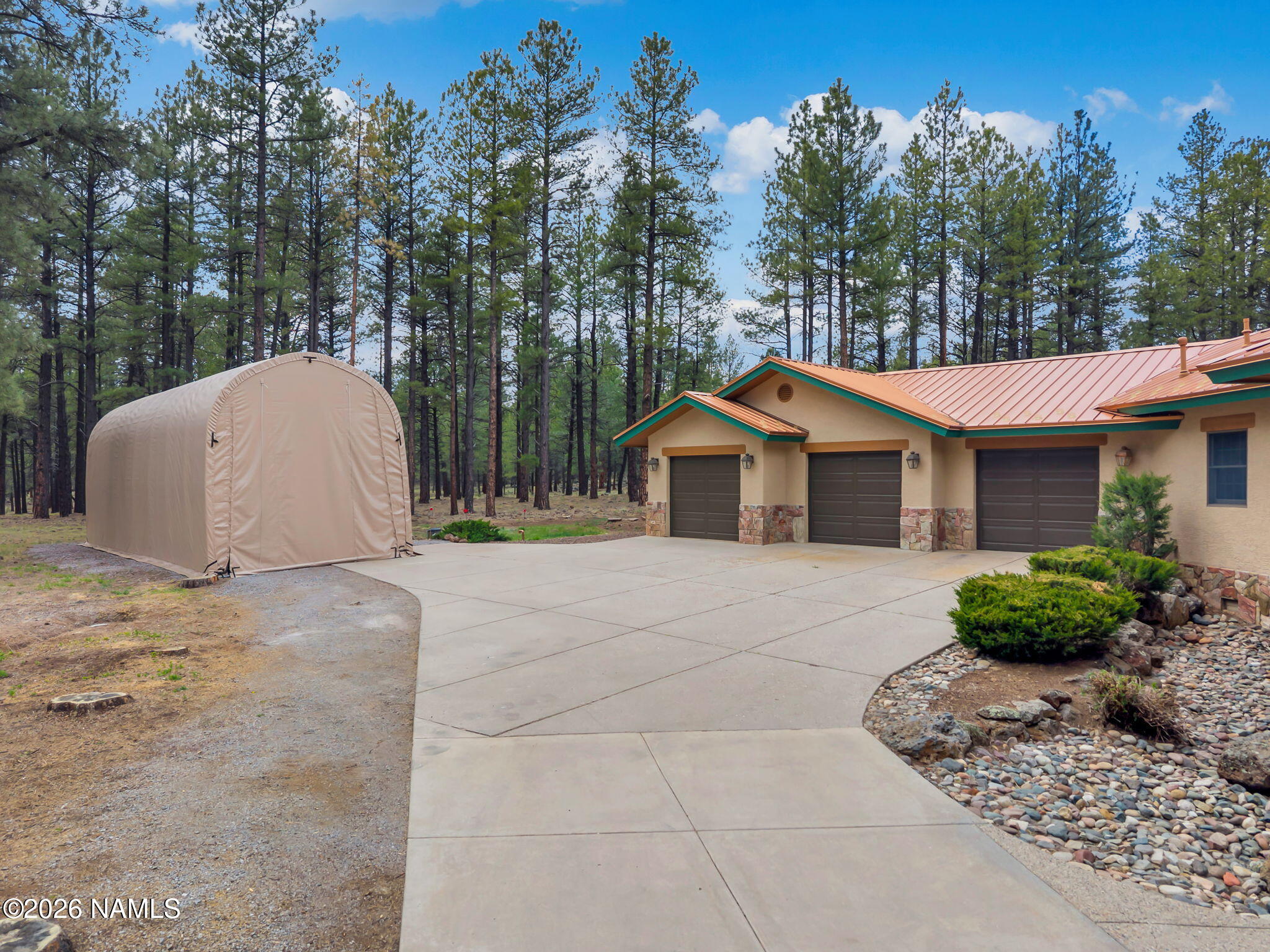 5415 North Fort Valley Road Flagstaff, AZ 86001 - Photo 5 of 64 a front view of a house with a yard and trees