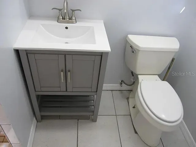 a white toilet sitting next to a bathroom sink