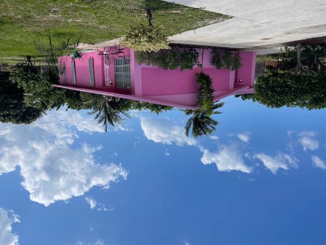 a view of a yard with an tree and a fence