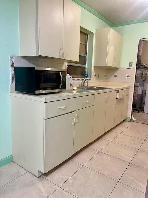 130 Mentone Road Boynton Beach, FL 33435 - Photo 12 of 26 a kitchen with a sink and cabinets