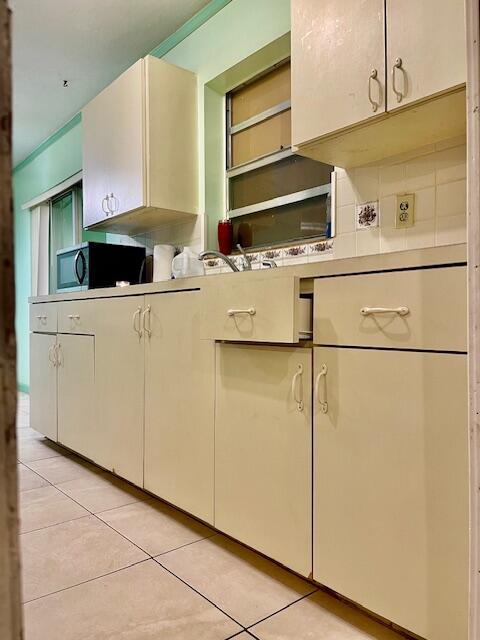 130 Mentone Road Boynton Beach, FL 33435 - Photo 13 of 26 a kitchen with stainless steel appliances a refrigerator and a cabinets