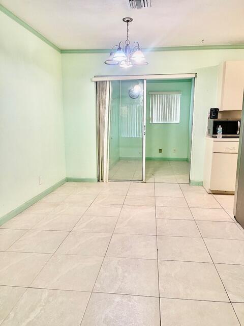 130 Mentone Road Boynton Beach, FL 33435 - Photo 15 of 26 a room with a chandelier and view of kitchen