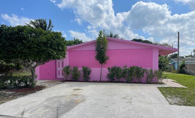 130 Mentone Road Boynton Beach, FL 33435 - Photo 2 of 26 a front view of a house with a yard and garage