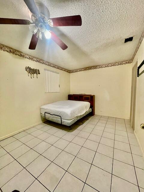 130 Mentone Road Boynton Beach, FL 33435 - Photo 26 of 26 a bedroom with a bed and a shower