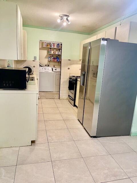 130 Mentone Road Boynton Beach, FL 33435 - Photo 9 of 26 a kitchen with stainless steel appliances a refrigerator and a stove