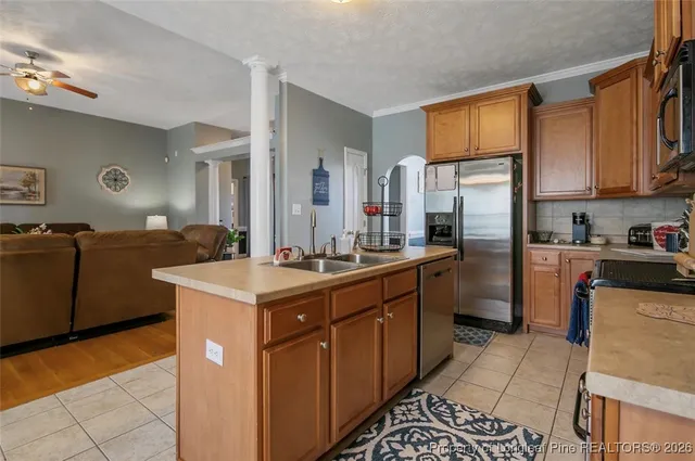 a kitchen with a sink stove and refrigerator