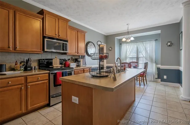 a kitchen with stainless steel appliances granite countertop a sink a stove and a wooden floors