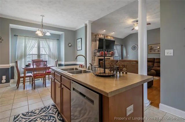a kitchen with sink cabinets and dining table