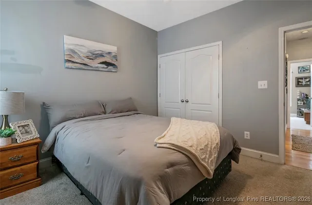 a bedroom with a bed and painting on the wall