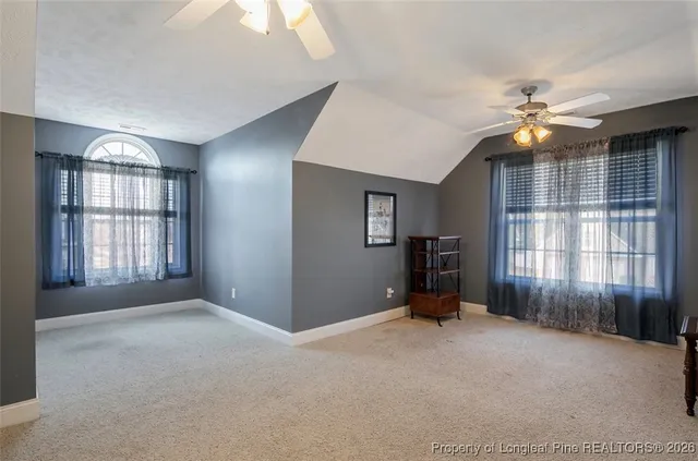 a view of a livingroom with a window and a ceiling fan
