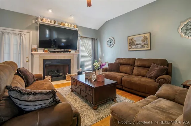 a living room with fireplace furniture and a flat screen tv