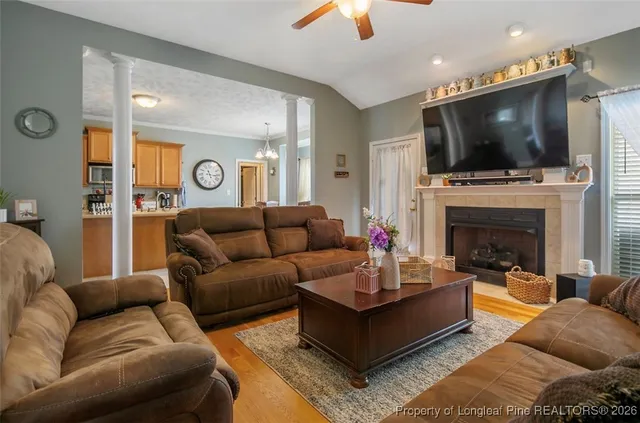 a living room with fireplace furniture and a flat screen tv
