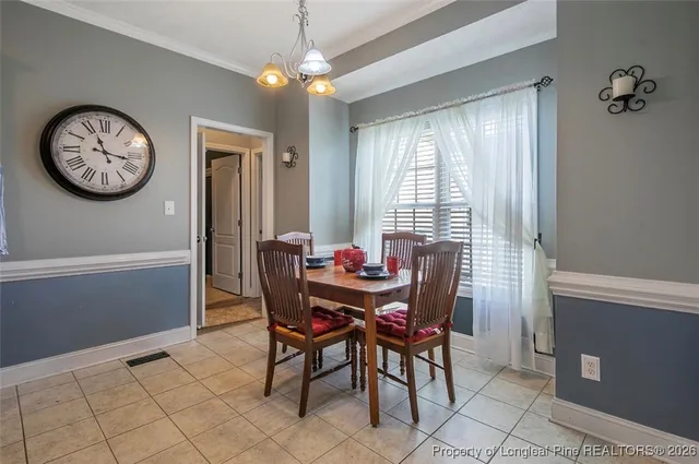 a view of a dining room with furniture window and chandelier