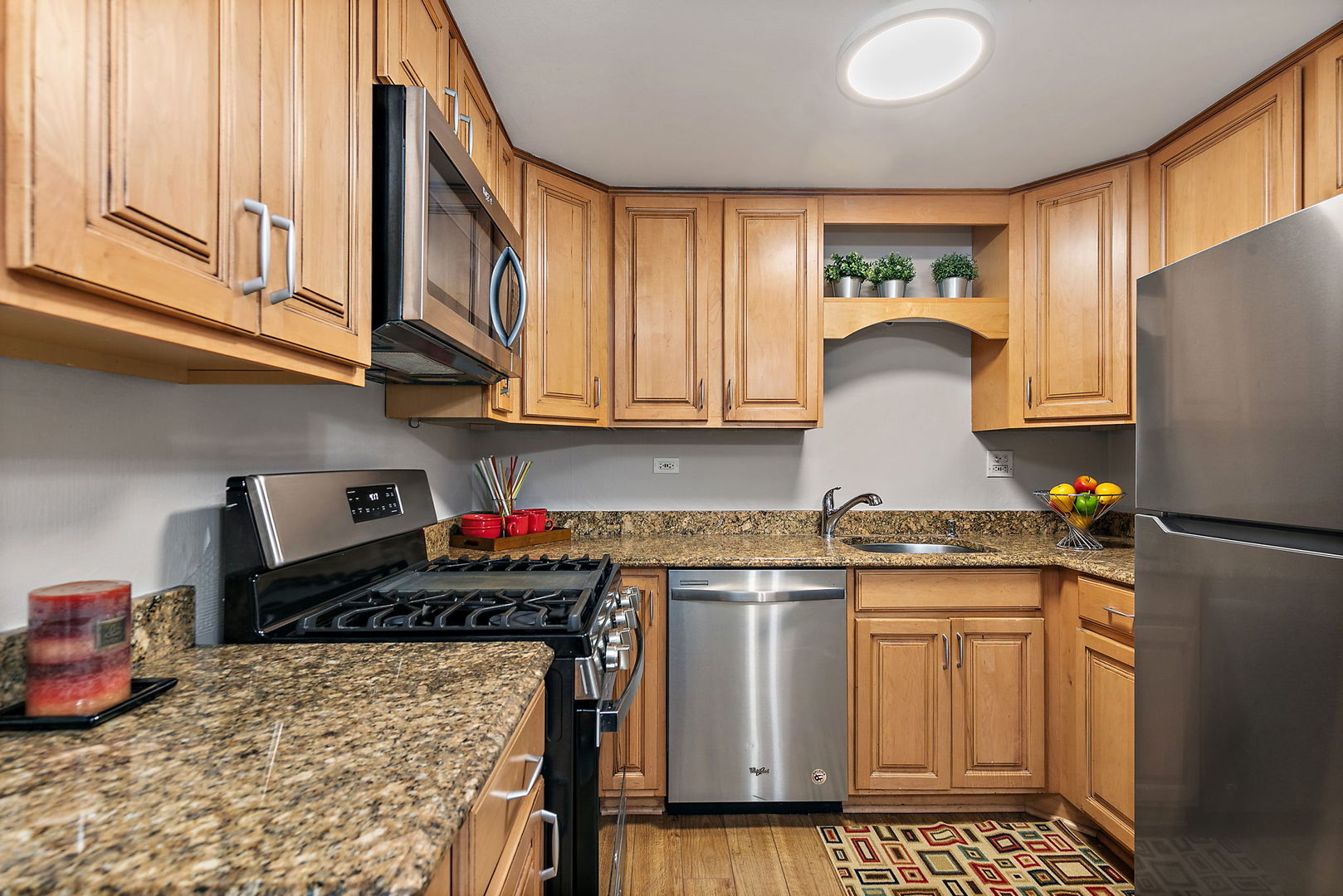 1303 Yarmouth Court, Unit 1303 Schaumburg, IL 60193 - Photo 6 of 11 a kitchen with stainless steel appliances granite countertop a stove a sink and a refrigerator