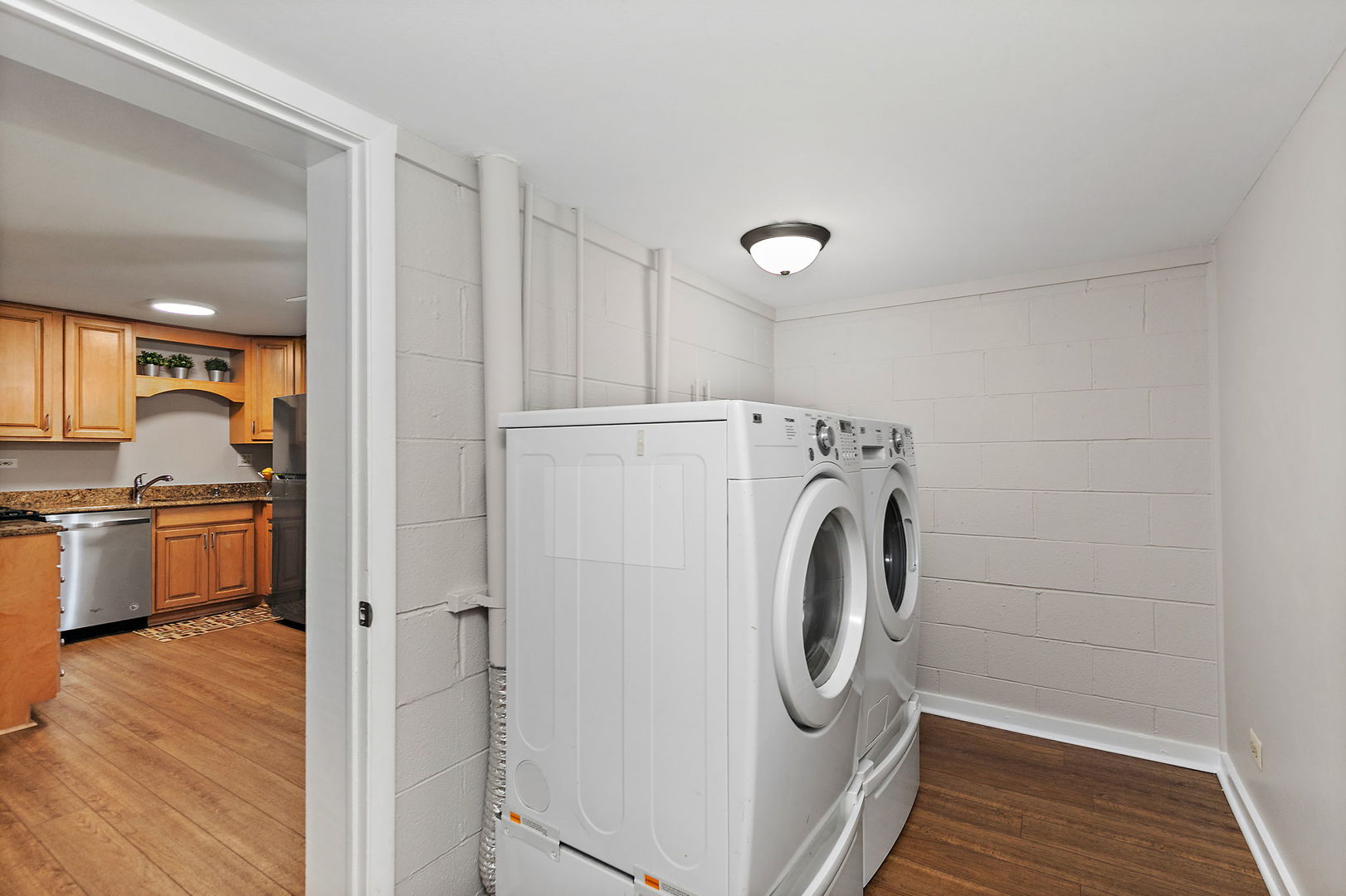 1303 Yarmouth Court, Unit 1303 Schaumburg, IL 60193 - Photo 7 of 11 a utility room with sink dryer and washer