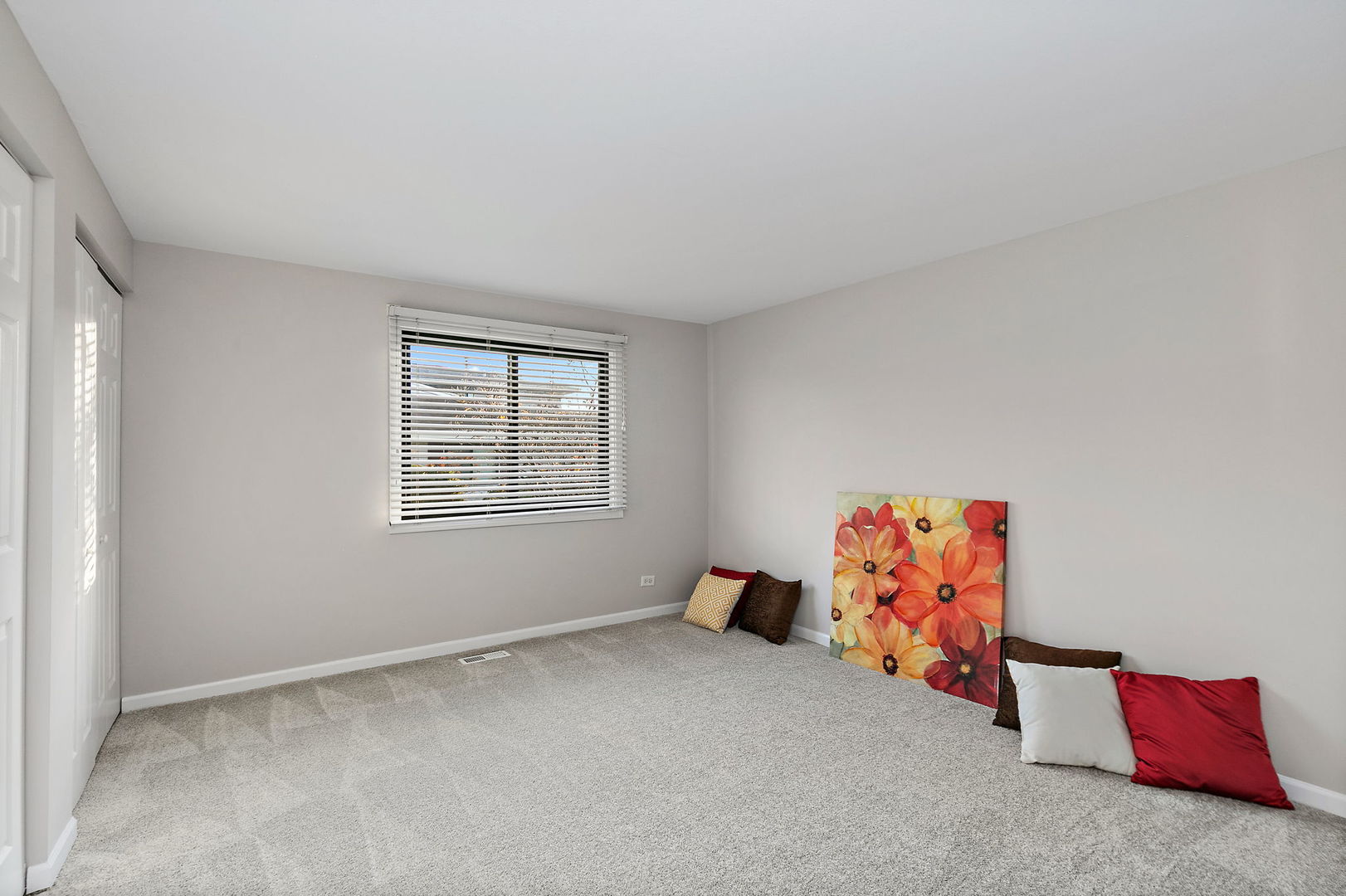 1303 Yarmouth Court, Unit 1303 Schaumburg, IL 60193 - Photo 10 of 11 an empty room with toys and a window