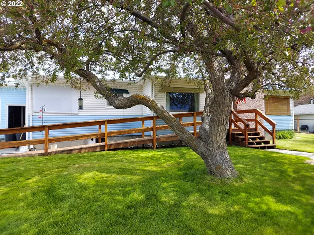 a house view with a sitting space and garden