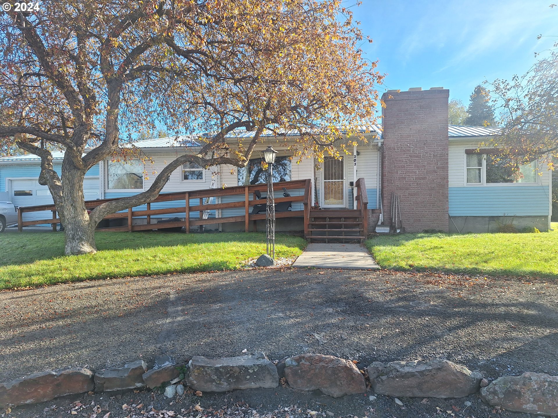 303 Northeast 2nd Street Enterprise, OR 97828 - Photo 19 of 19 a view of a house with a yard and a large tree