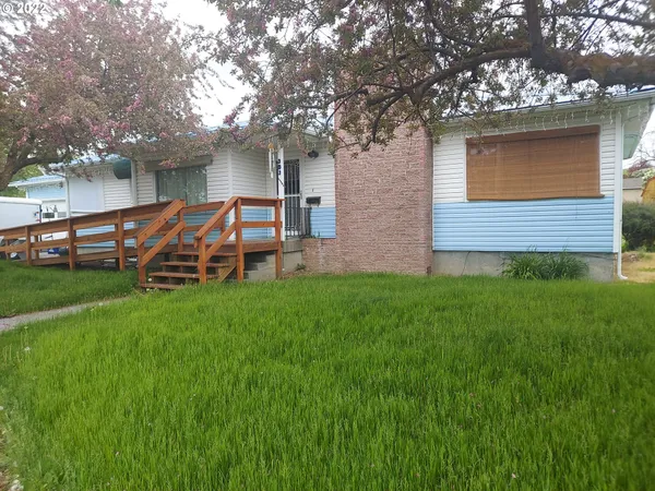 a view of a house with a yard porch and sitting area