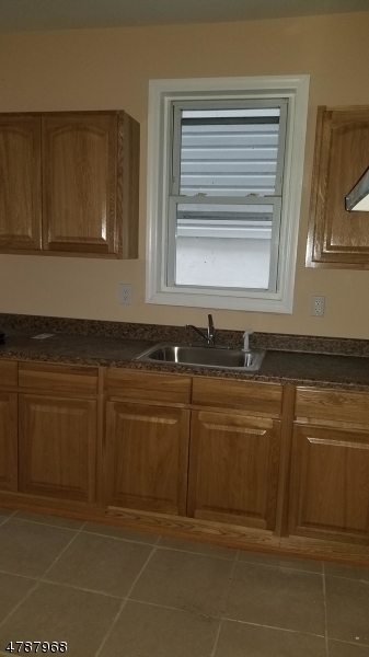 553 Walnut Street, Unit 1 Elizabeth, NJ 07201 - Photo 1 of 8 a kitchen with granite countertop a sink and a stove