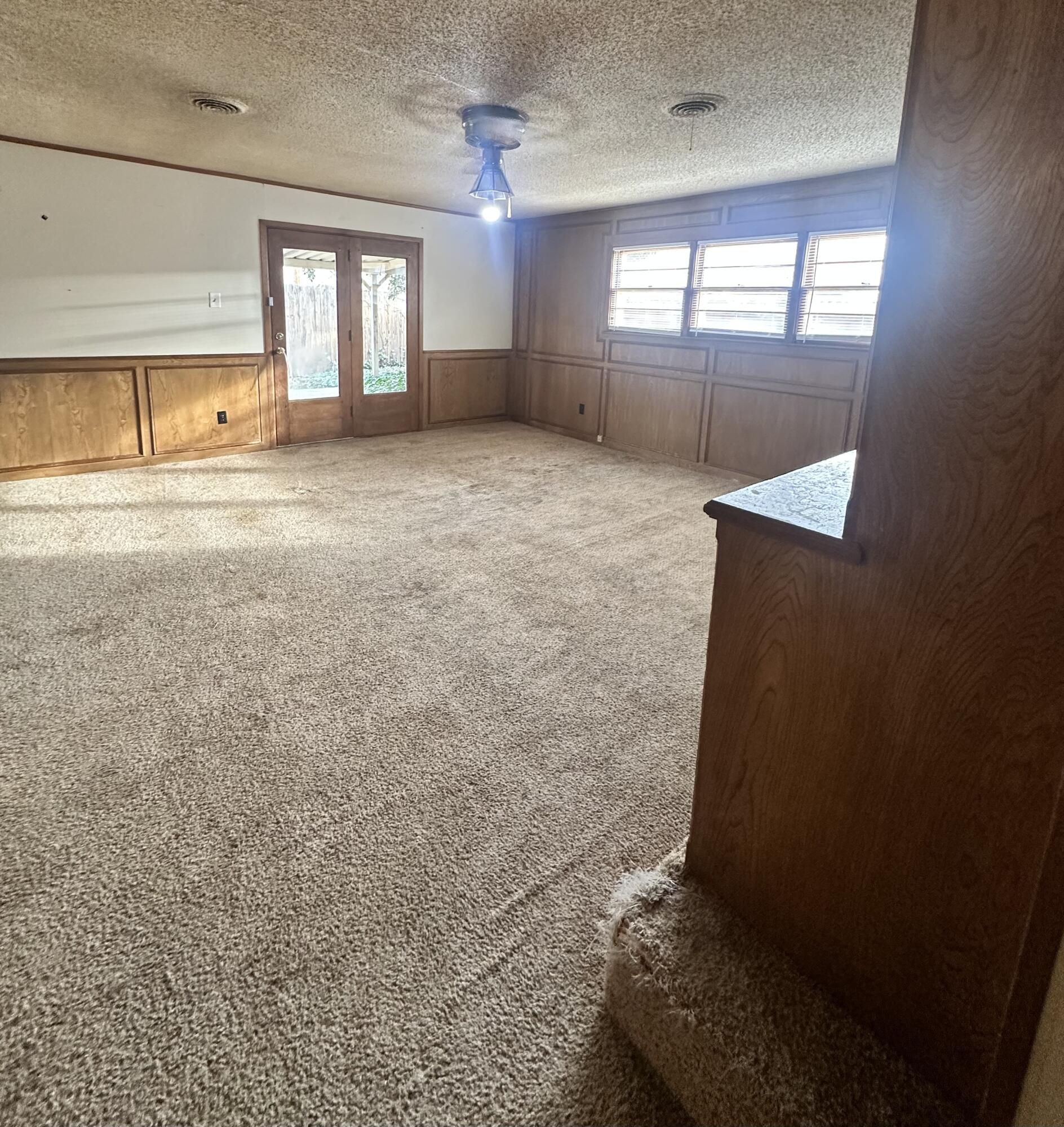 4918 14th Street Lubbock, TX 79416 - Photo 11 of 38 wooden floor in an empty room with a window