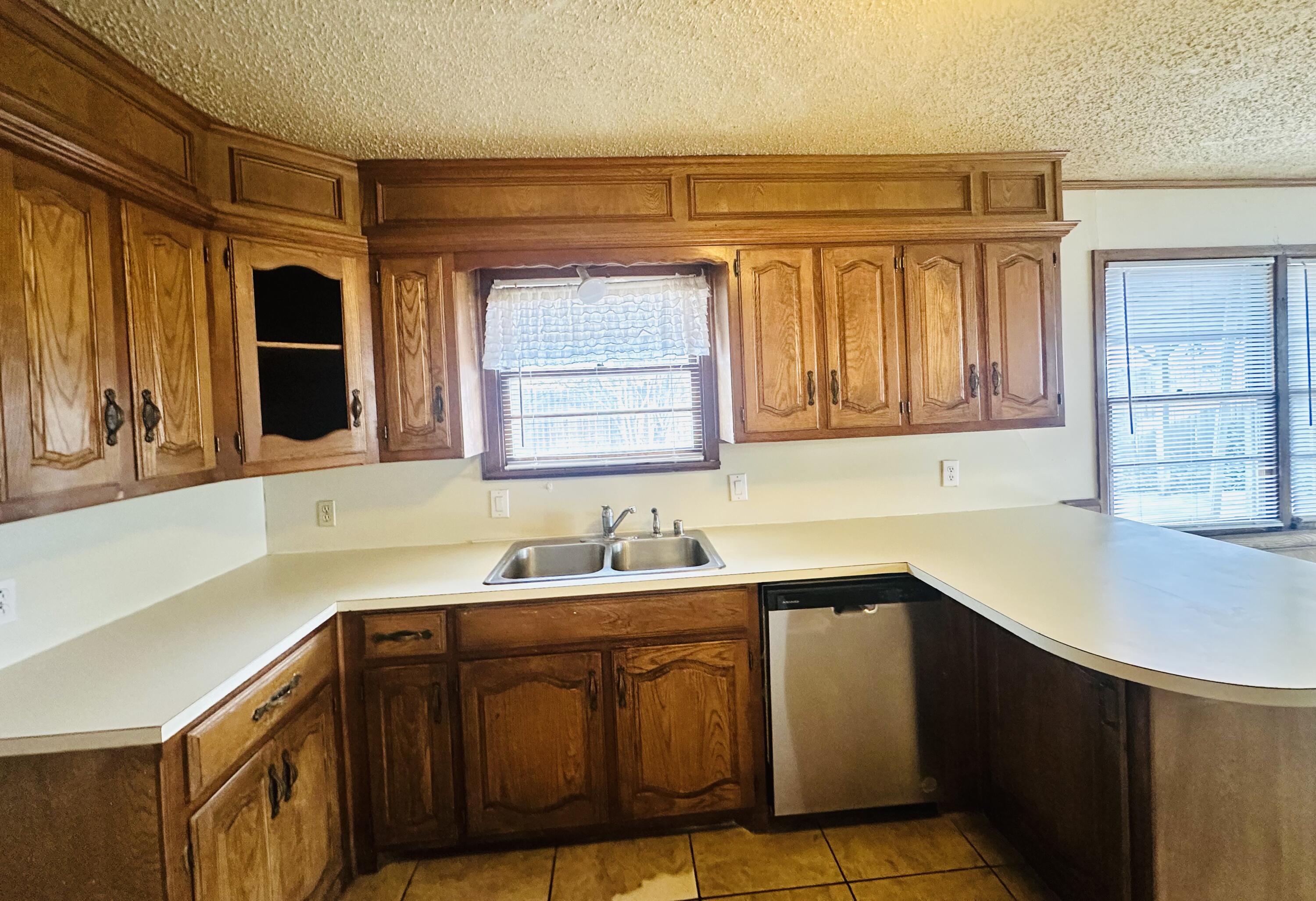 4918 14th Street Lubbock, TX 79416 - Photo 17 of 38 a kitchen with a sink cabinets and window