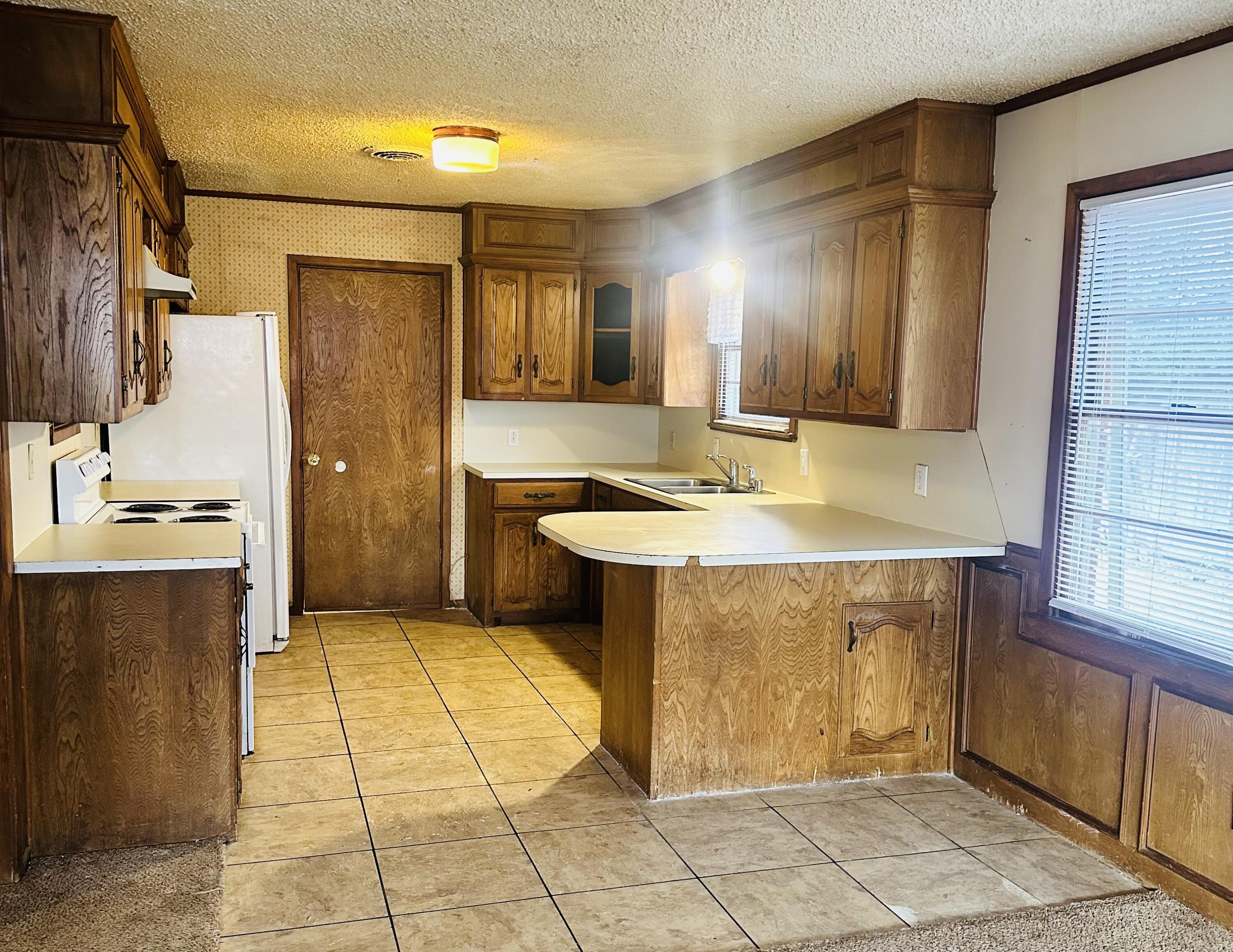 4918 14th Street Lubbock, TX 79416 - Photo 18 of 38 a bathroom with a sink a mirror and a shower