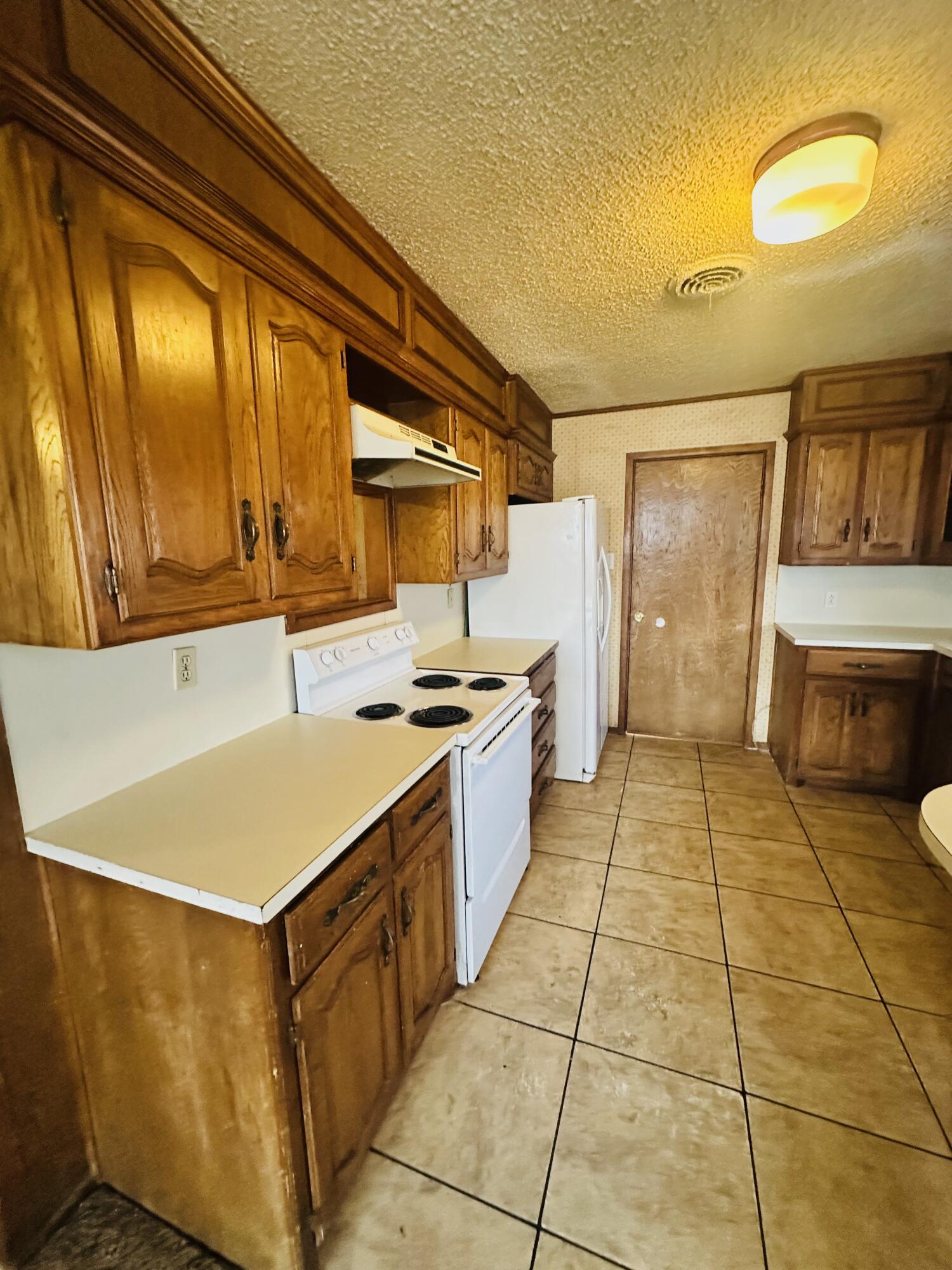 4918 14th Street Lubbock, TX 79416 - Photo 21 of 38 a kitchen with a cabinets and appliances
