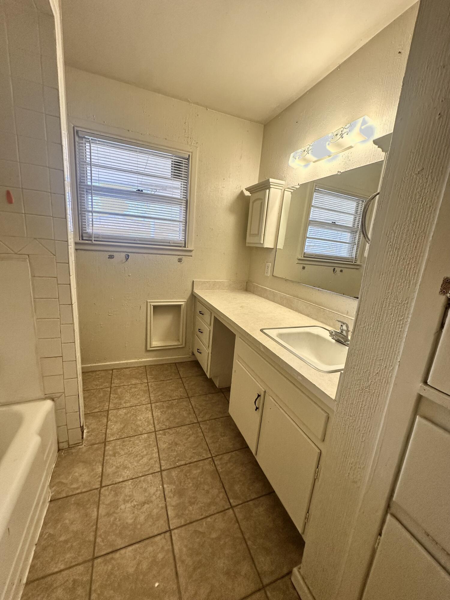 4918 14th Street Lubbock, TX 79416 - Photo 23 of 38 a bathroom with a sink a toilet and shower