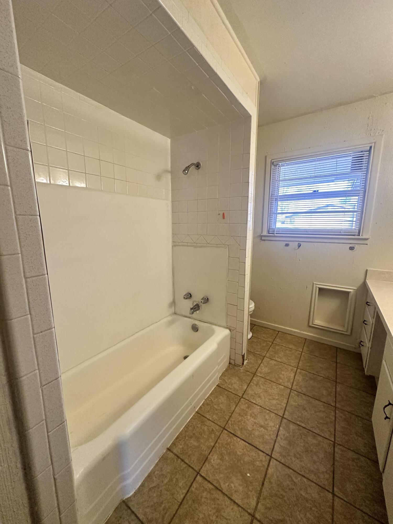 4918 14th Street Lubbock, TX 79416 - Photo 25 of 38 a bathroom with a bathtub and shower