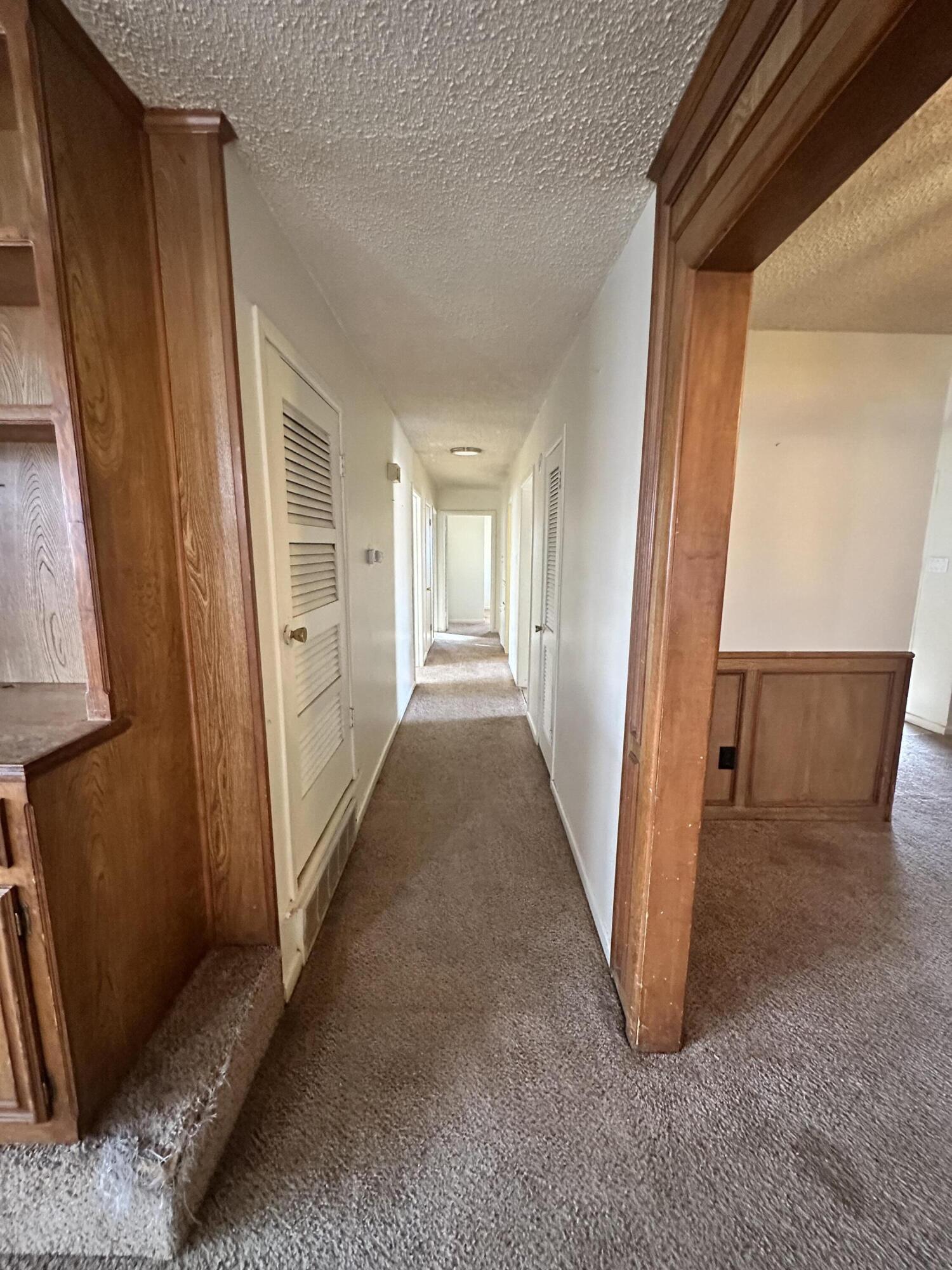 4918 14th Street Lubbock, TX 79416 - Photo 32 of 38 a view of a hallway to a house with wooden floor and stairs