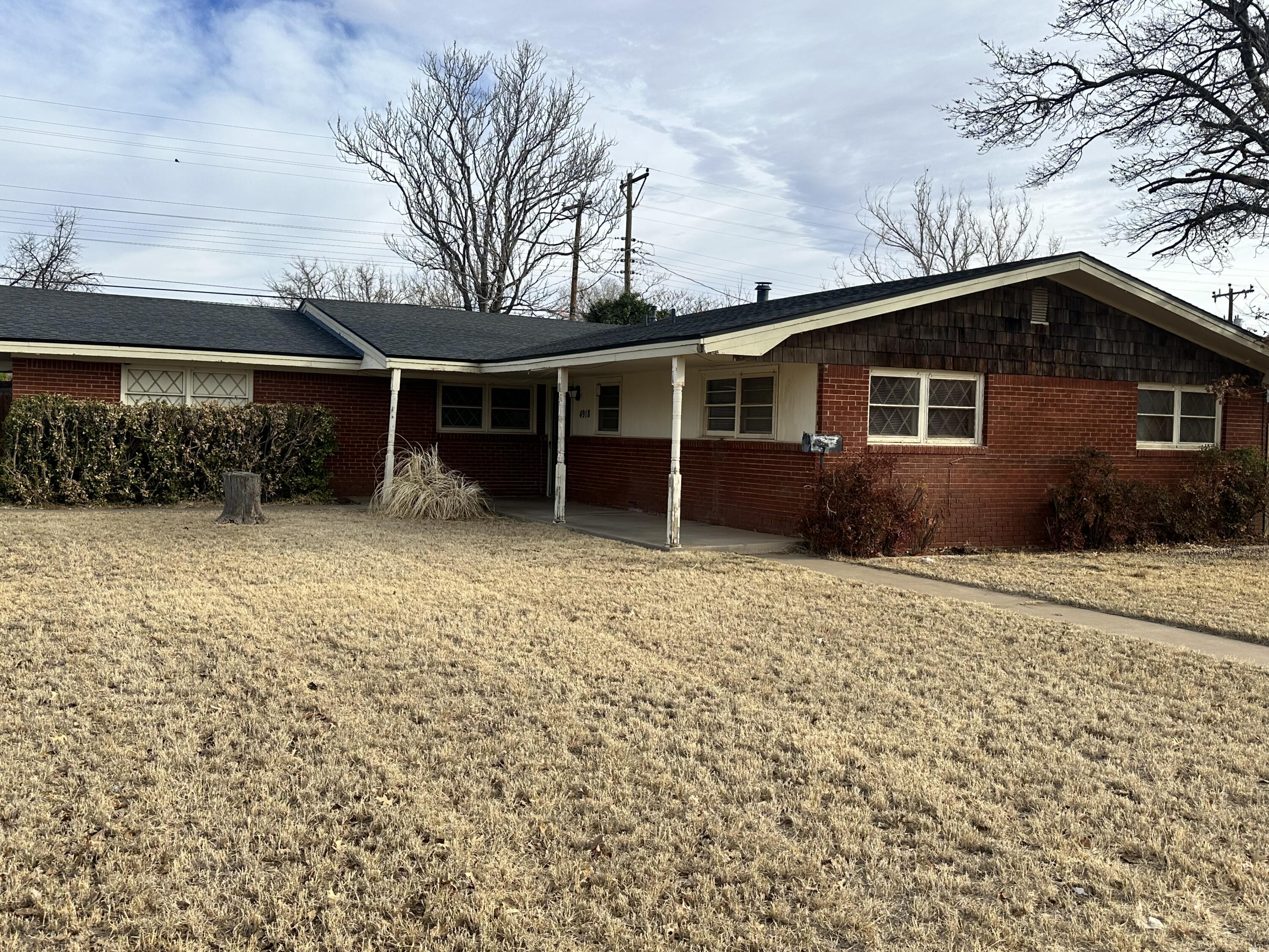 4918 14th Street Lubbock, TX 79416 - Photo 4 of 38 a front view of house with yard and trees around