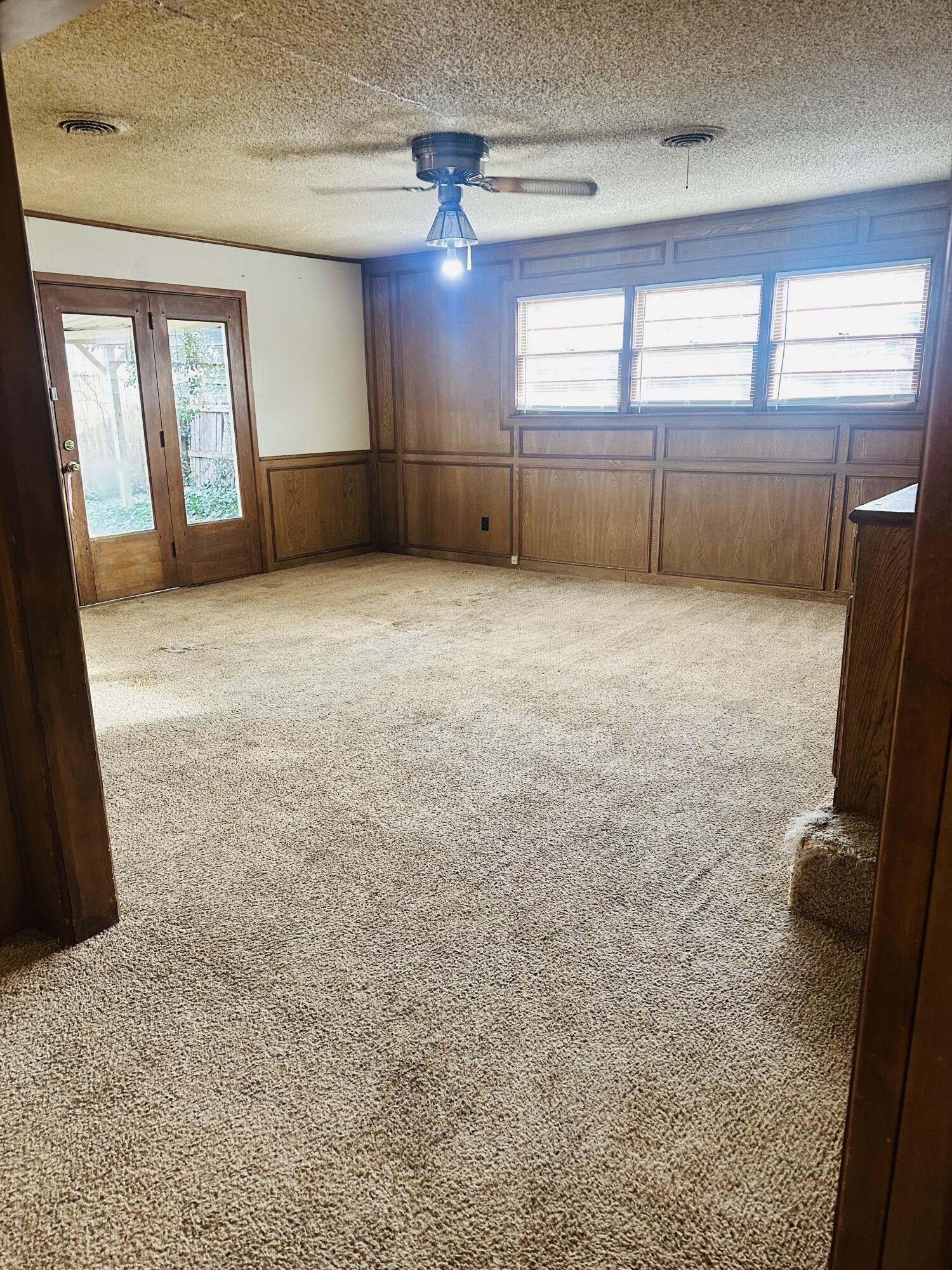 4918 14th Street Lubbock, TX 79416 - Photo 7 of 38 a view of an empty room with a fireplace