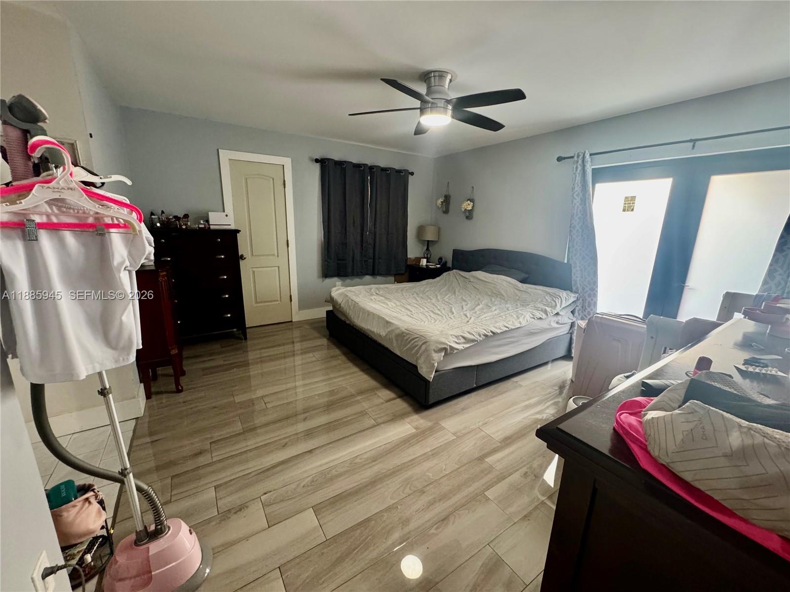 11178 Southwest 74th Terrace Miami, FL 33173 - Photo 15 of 18 a spacious bedroom with two beds and a chandelier