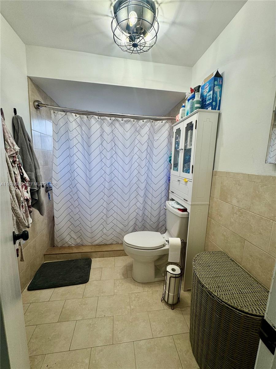 11178 Southwest 74th Terrace Miami, FL 33173 - Photo 17 of 18 a bathroom with a toilet and a shower