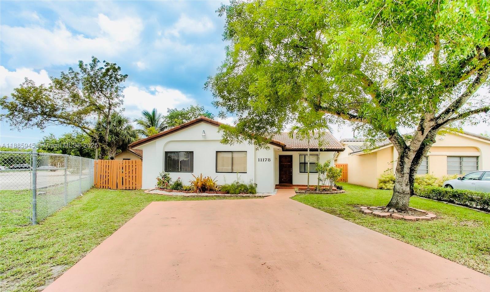 11178 Southwest 74th Terrace Miami, FL 33173 - Photo 2 of 9 a front view of house with yard and green space
