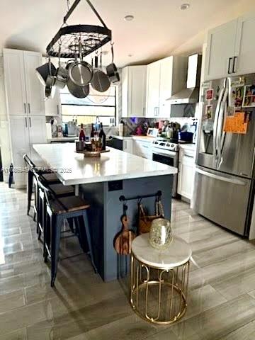 11178 Southwest 74th Terrace Miami, FL 33173 - Photo 3 of 18 a kitchen with stainless steel appliances a table chairs and stove
