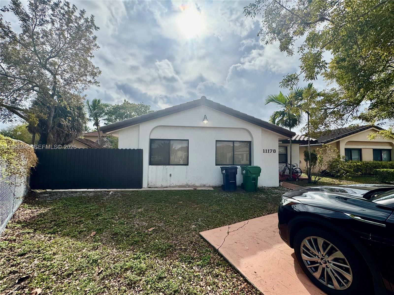 11178 Southwest 74th Terrace Miami, FL 33173 - Photo 8 of 18 a front view of a house with a yard